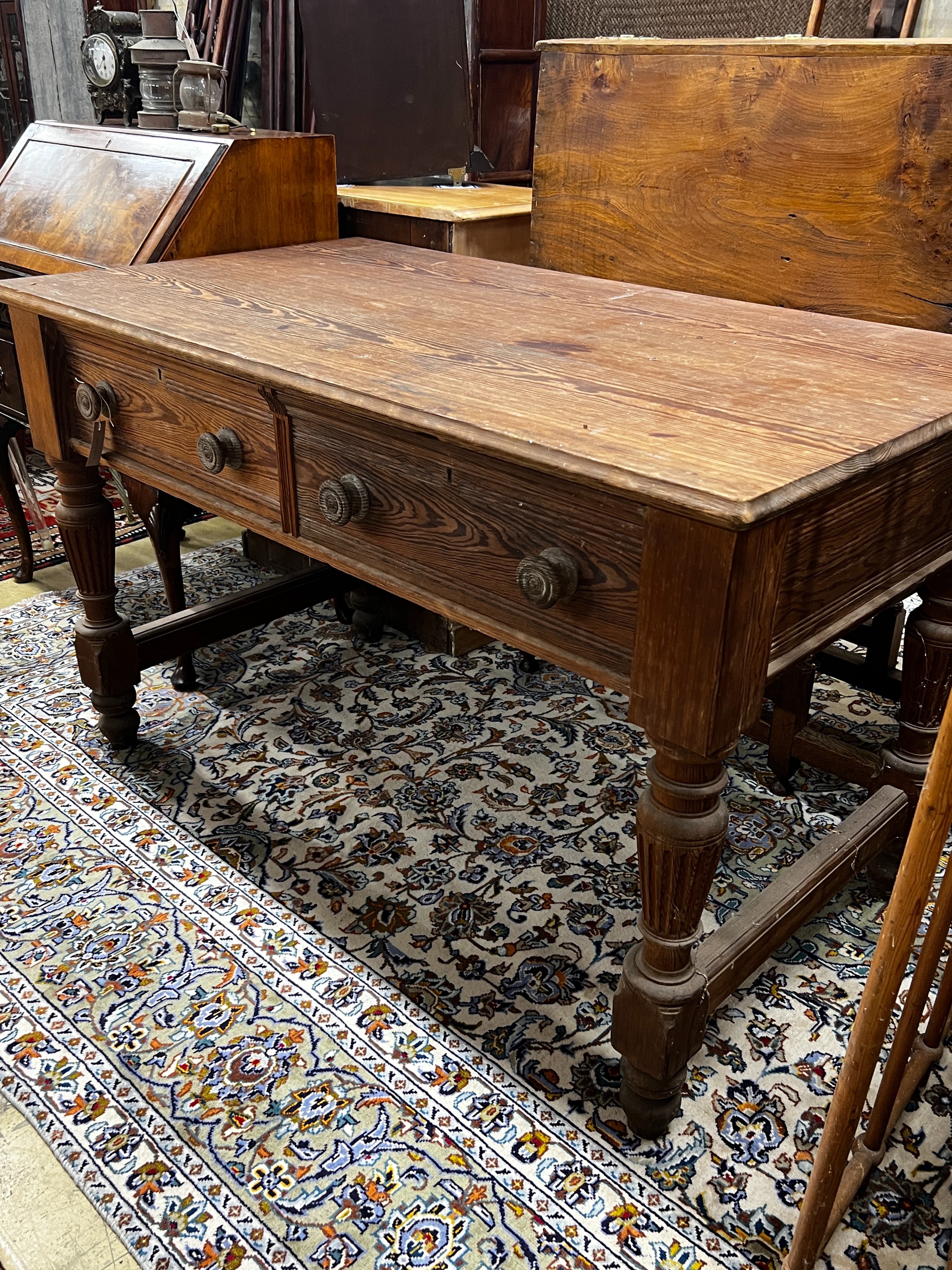 A Victorian stained pitch pine two drawer serving table by repute from Balmoral Castle kitchens, length 136cm, width 76cm, height 84cm